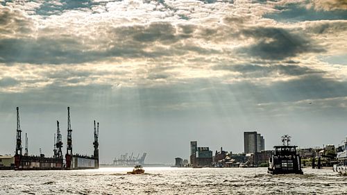 Port of Hamburg with ships and dry dock during cloudy weather