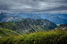 Endless Alps — A panoramic view beneath a dramatic sky by Vos Photography