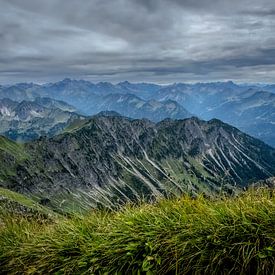 Endless Alps — A panoramic view beneath a dramatic sky by Vos Photography