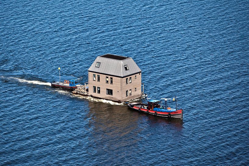 Aerial photo of the transport of a waterville over the IJsselmeer by Frans Lemmens