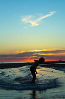 Surfing in Zeeland at sunset.