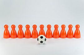 Conceptuele oranje speelpionnen als voetbalelftal