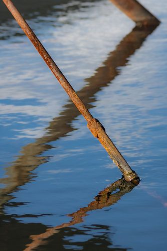 Reflection rusty steel cable in water