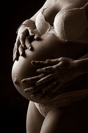 Couple embraces pregnant woman belly by Jörg B. Schubert