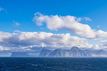 Uitzicht op de rotsen van de Faeröer met wolken van Rico Ködder