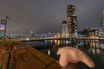 Bollard close-up shot with the The Rijnhaven bridge and the Hotel New York in the background by Gea Gaetani d'Aragona