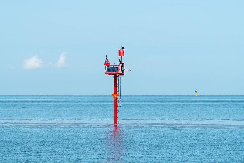 Red painted beacon with solar panel in the Wadden Sea by Wim Stolwerk