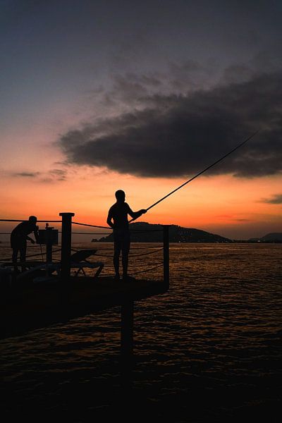 Fisherman at sunset by Mert Sezer