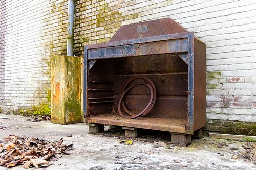 Urbex - Old rusty cupboard against a weathered wall