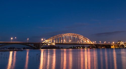 Waal bridge Nijmegen in the evening at high tide