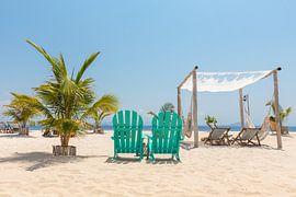 White sand and a sea view off a paradisiacal beach resort on a deserted island by Michiel Ton