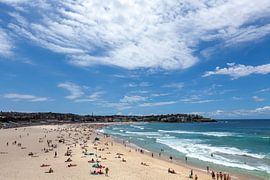 Wave breaks and surf on clear sand of famous Australian Sydney Bondi beach by Tjeerd Kruse