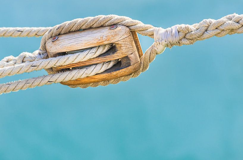Sailing boat pulley, block and tackle with moored nautical rope, close-up by Alex Winter