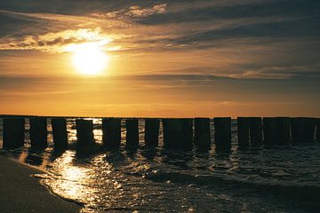 Groyne in Zingst aan de Oostzee, reikend in de zee bij zonsondergang. van Martin Köbsch