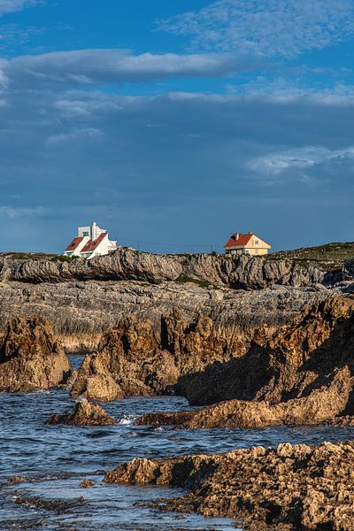 Two houses on the rocky coast of northern Spain in the evening light by Harrie Muis