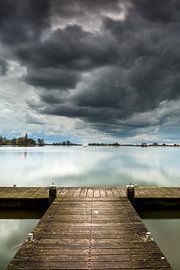 Wolkenlucht met aanlegplaats en zeilboot by Peet Romijn