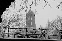 Cathedral tower in winter with bicycles in foreground