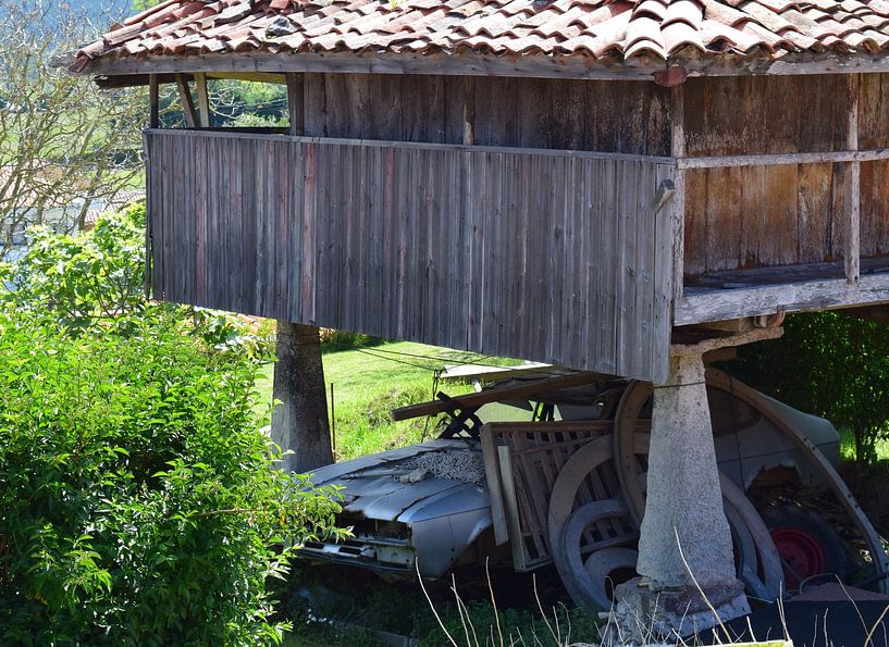 Traditioneller Getreidespeicher in Nordspanien mit einem Autowrack darunter von Studio LE-gals
