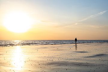 Beach walker with setting sun by Marika Rentier