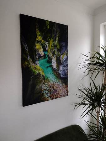 Blue water in a gorge with moss on the rocks