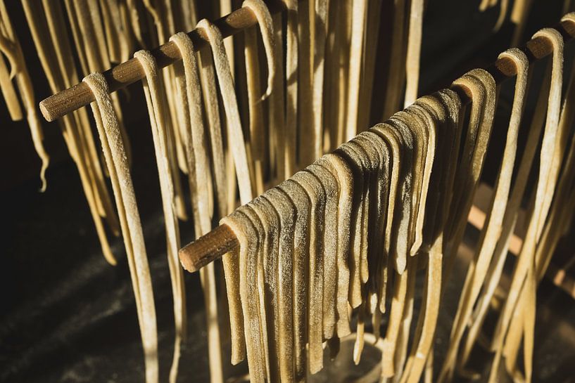 Sunlit Homemade Pasta Hanging to Dry by Imladris Images