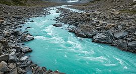 Turquoise-blue glacial river in a rugged rocky landscape by ButterflyPix