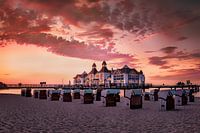 Beach with beach chairs and pier on Rügen in the sunset