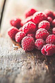 Juicy raspberries on a wooden table by Poster Art Shop