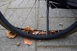 Flat tire of bicycle with autumn leaves by Studio LE-gals