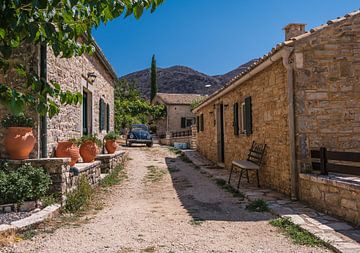 Volkswagen beetle in old Greek village by Michel Knikker