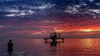 Sunset by the sea with an outrigger canoe