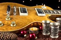 E-Guitar with cup and candle christmasy decorated
