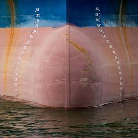 The bow of a ship with rust and calibration marks by scheepskijkerhavenfotografie