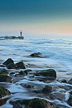 Scheveningen Pier with the rocks of a breakwater in the surf by gaps photography