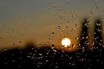 Raindrops on the window at sunrise by Heiko Kueverling