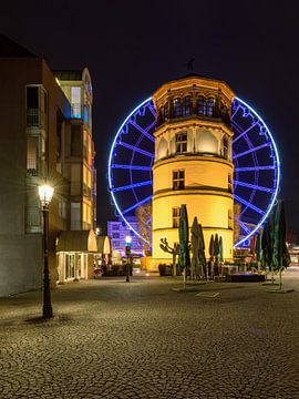Castle tower in Dusseldorf and blue ferris wheel van Michael Valjak