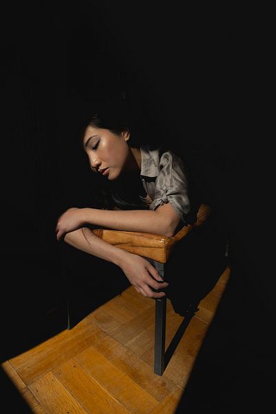 Asian woman in sunlight by Bart van Lier