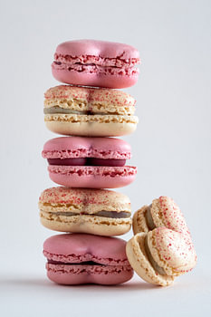 A stack of delicious macarons in yellow and pink l Food Photography