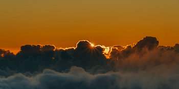 Golden sunset above a sea of clouds – Sunstar panorama