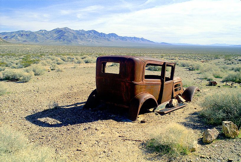 Old classic rusty car wreck abandoned in desert by Frans Rombout
