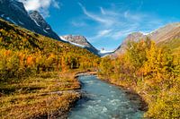 River through valley with glacier in the background.