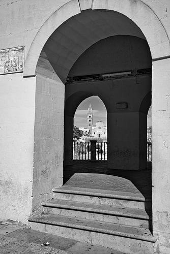 View through a double see through arch in Matera in black and white
