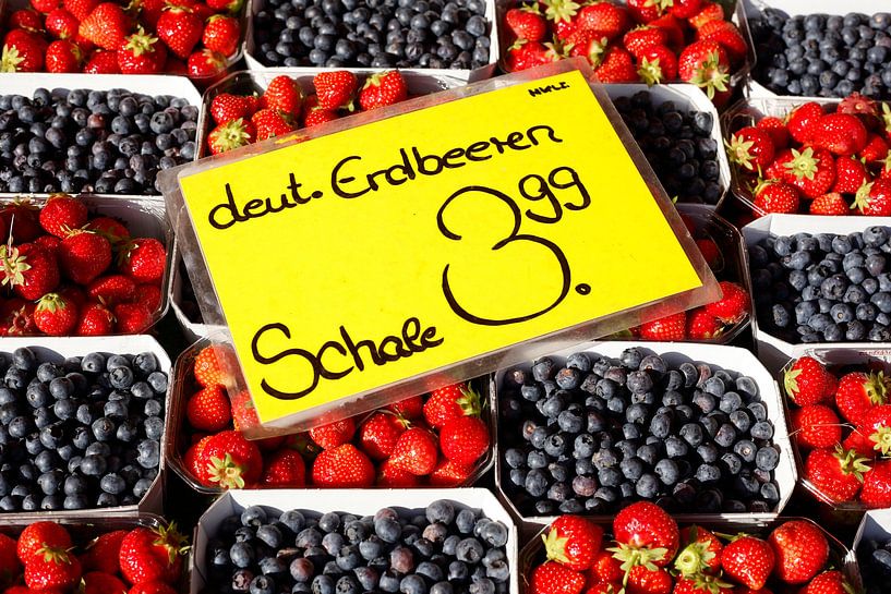 Fresh strawberries and blueberries in trays on a market stall, Bremen, Germany by Torsten Krüger