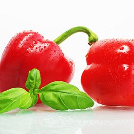Fresh red peppers with water drops and basil leaves by Tanja Riedel