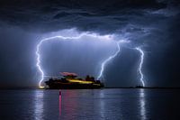 Ship sails out during a severe thunderstorm