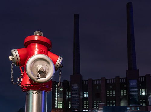 red hydrant in front of the power station