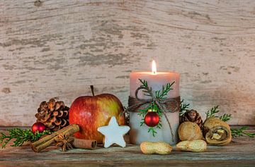 Kerst- en adventsdecoratie met versierde kaarsvlam, rode appel, noten en sterrenkoekje van Alex Winter