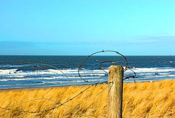 Het strand achter prikkeldraad