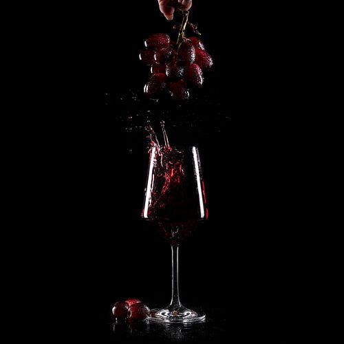 grape splash in a glass of red wine