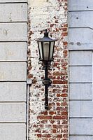 Old lantern against building